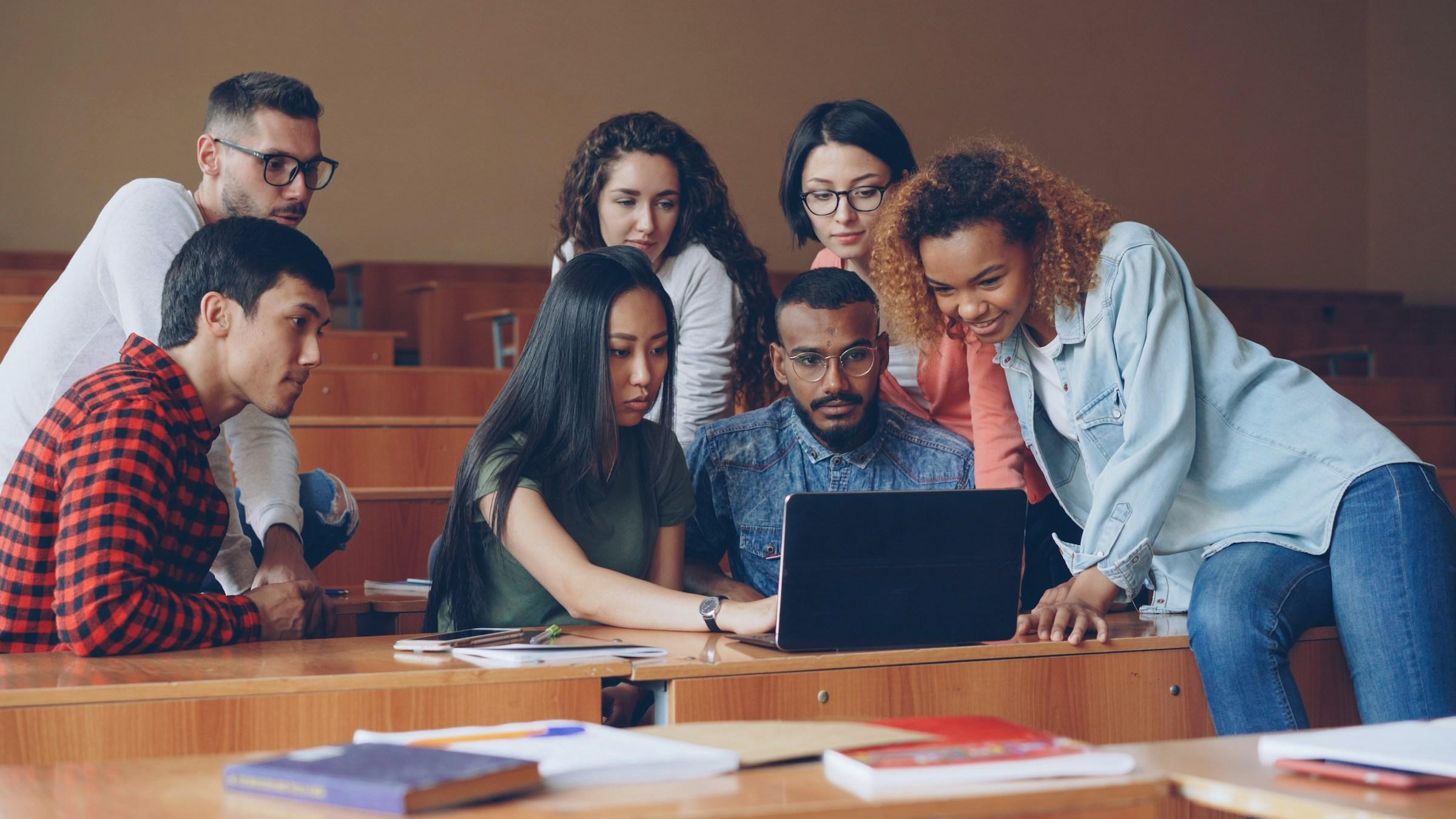 University students reviewing career aptitude test results together on a laptop