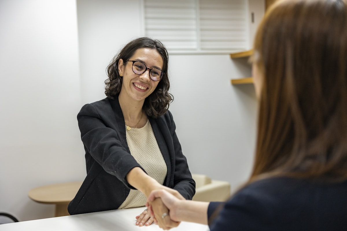 Two professionals shaking hands after a successful hire